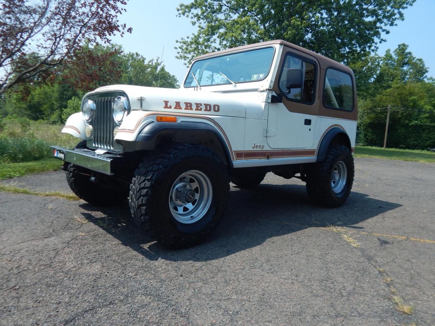 1983 White /Tan Jeep CJ7 Base (1JCCN87E0DT) with an 4.2L L6 OHV engine, Manual transmission, located at 6528 Lower York Road, New Hope, PA, 18938, (215) 862-9555, 40.358707, -74.977882 - Here we have a 1983 CJ-7 Laredo with a 4.2L straight six putting power to an 4x4 manual transmission. This CJ has saddle colored leather seats, sliding windows, hard top, lockers on both axles, new muffler, new bearings and 15 inch alloy wheels with 4 Mickey Thompson tires. This vehicle is being off - Photo#0
