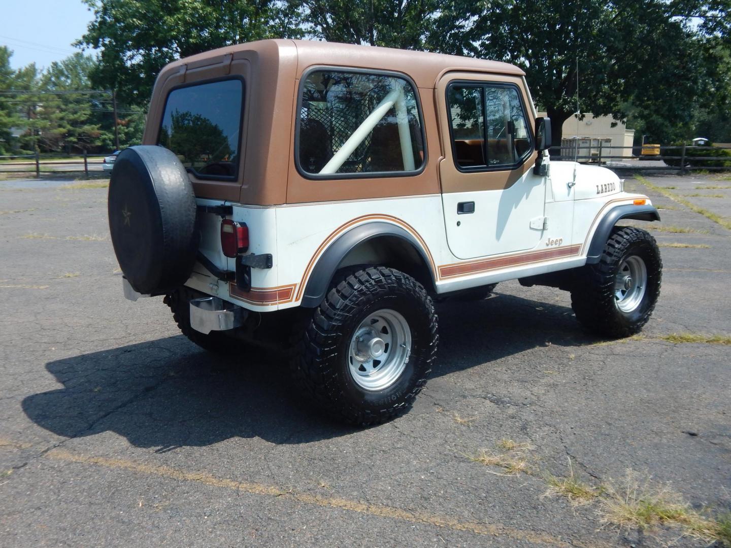 1983 White /Tan Jeep CJ7 Base (1JCCN87E0DT) with an 4.2L L6 OHV engine, Manual transmission, located at 6528 Lower York Road, New Hope, PA, 18938, (215) 862-9555, 40.358707, -74.977882 - Here we have a 1983 CJ-7 Laredo with a 4.2L straight six putting power to an 4x4 manual transmission. This CJ has saddle colored leather seats, sliding windows, hard top, lockers on both axles, new muffler, new bearings and 15 inch alloy wheels with 4 Mickey Thompson tires. This vehicle is being off - Photo#3