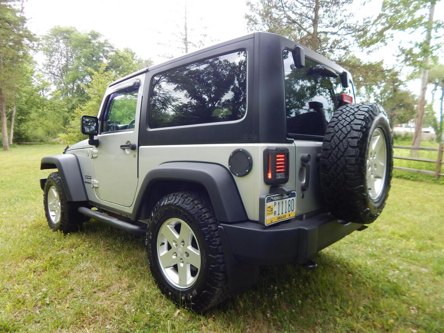 2011 Silver /Black Jeep Wrangler Sport 4WD (1J4AA2D12BL) with an 3.8L V6 OHV 12V engine, Automatic transmission, located at 6528 Lower York Road, New Hope, PA, 18938, (215) 862-9555, 40.358707, -74.977882 - Here we have a 2011 Jeep Wrangler Sport with a 3.8L V6 putting power to an automatic 4x4 transmission. Options include: black cloth, heat and AC, JVC aftermarket radio, cruise control, tilt steering wheel, 3 piece hard top, power windows/locks/mirrors, 17 inch alloy wheels with 4 Goodyear Wrangler t - Photo#2