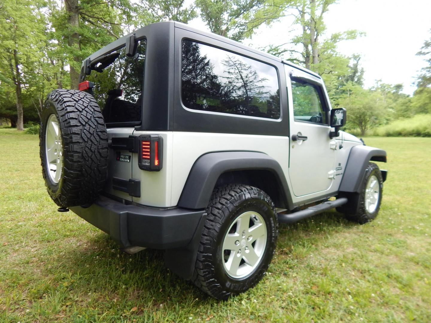 2011 Silver /Black Jeep Wrangler Sport 4WD (1J4AA2D12BL) with an 3.8L V6 OHV 12V engine, Automatic transmission, located at 6528 Lower York Road, New Hope, PA, 18938, (215) 862-9555, 40.358707, -74.977882 - Here we have a 2011 Jeep Wrangler Sport with a 3.8L V6 putting power to an automatic 4x4 transmission. Options include: black cloth, heat and AC, JVC aftermarket radio, cruise control, tilt steering wheel, 3 piece hard top, power windows/locks/mirrors, 17 inch alloy wheels with 4 Goodyear Wrangler t - Photo#4